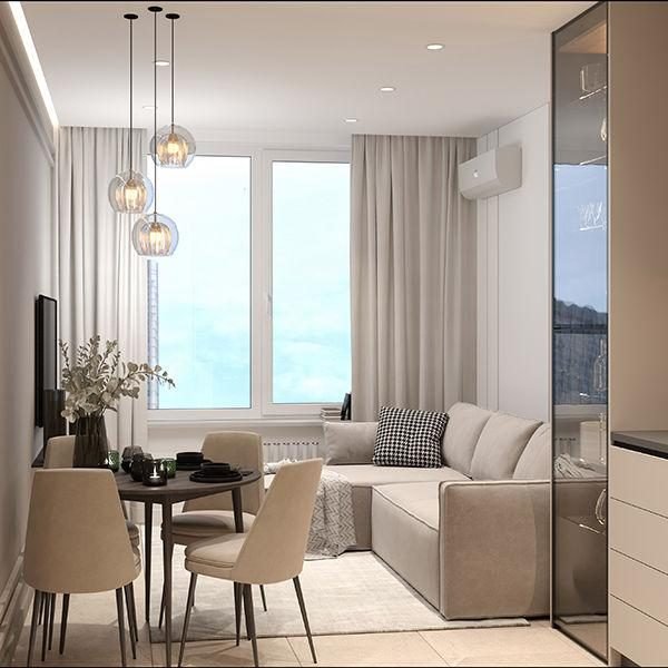 Compact apartment living room with a corner sofa, small round dining table, glass pendants and full-height curtains