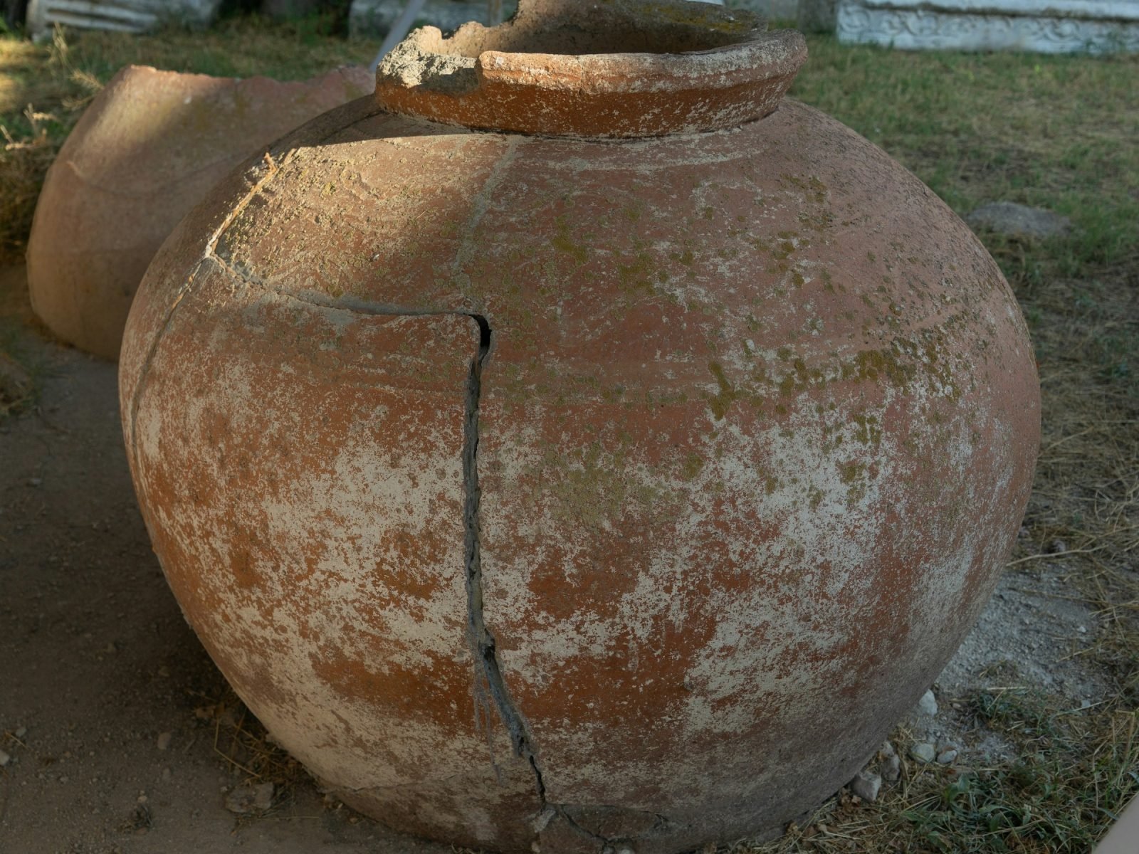 Large terracotta vessel with a long crack running down its side