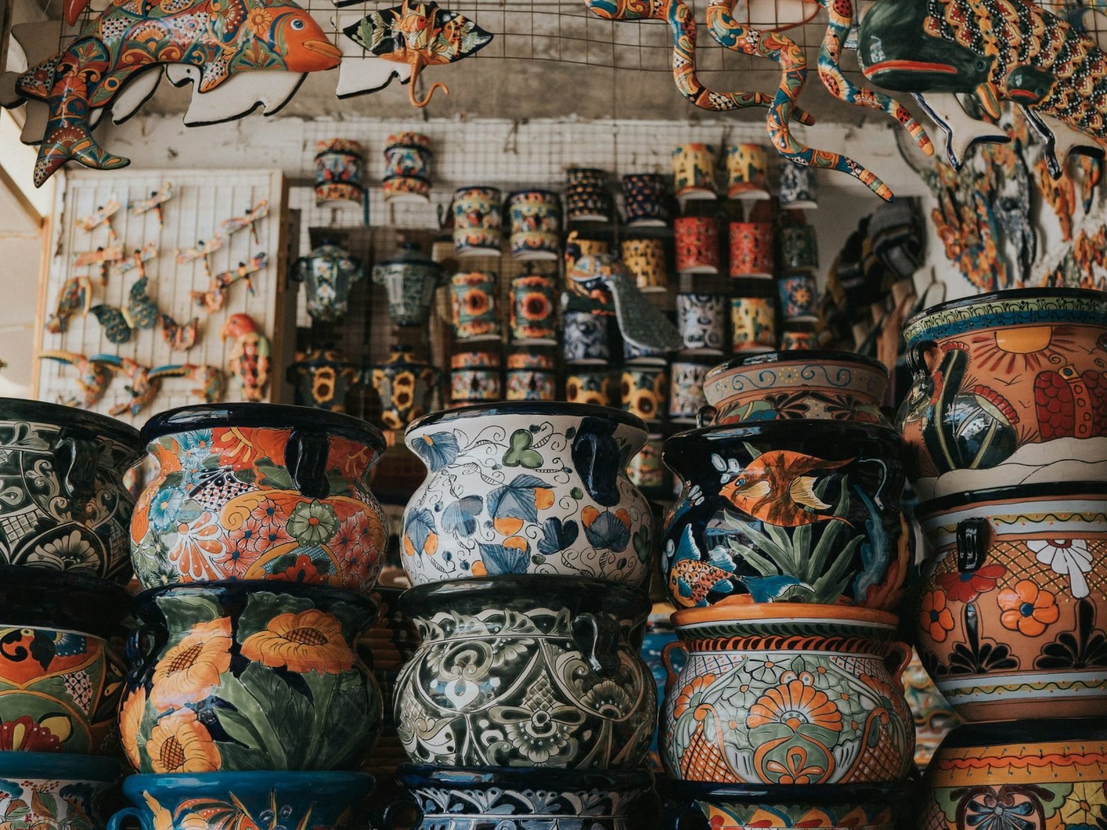 Shelves of hand-painted Mexican pottery in bright traditional patterns