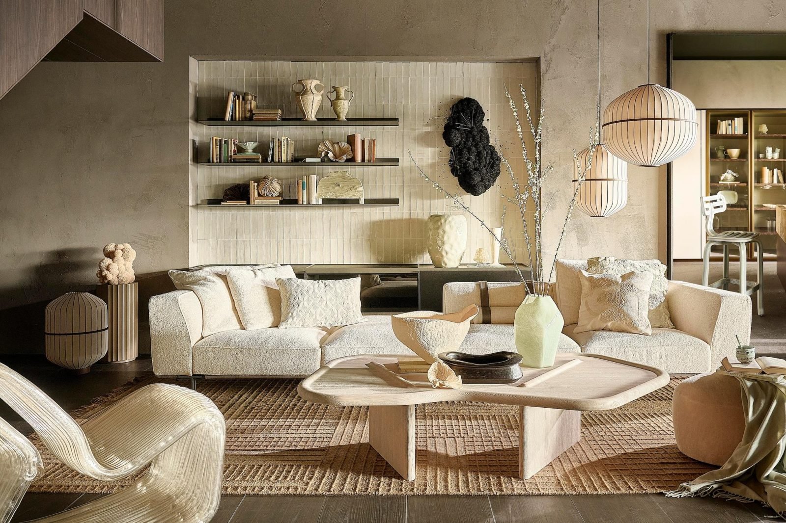 Living room with open shelves, paper lantern pendants, sculptural objects and a cream sofa