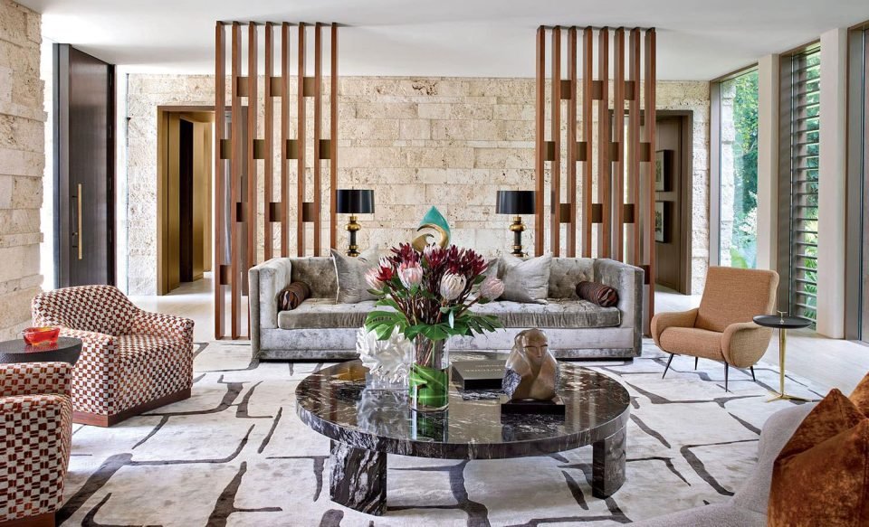 Living room with timber screen partitions, marble coffee table and patterned armchairs