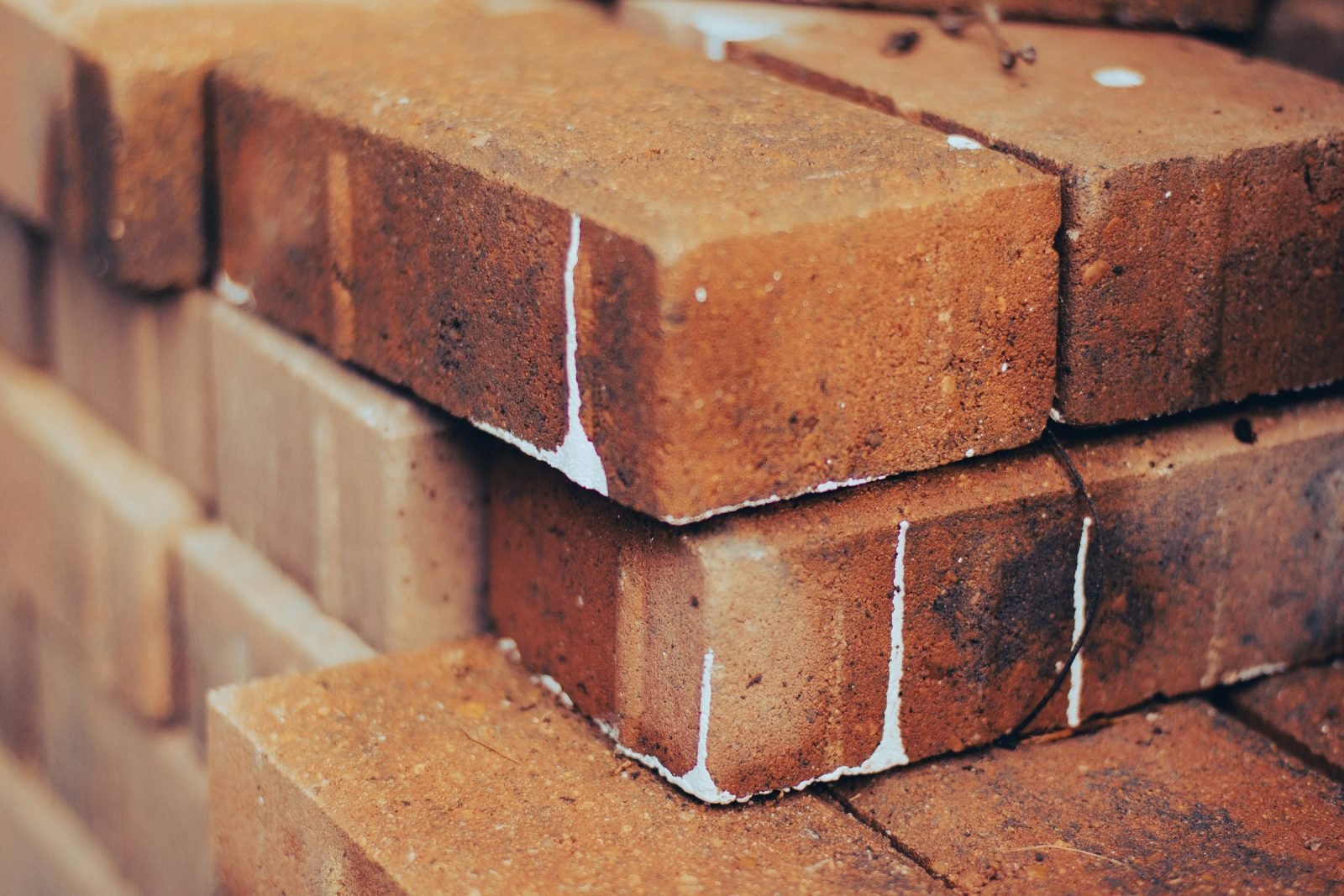Close-up of stacked red bricks ready for laying